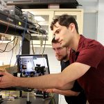 U of T doctoral researchers Iliya Sigal (right) and Dene Ringuette are part of a team that designed a miniature microscope that could open new doors for epilepsy and seizure monitoring and treatment. (Credit: Luke Ng).