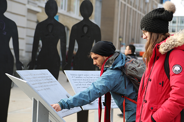 Students interact with the monument to commemorate the National Day of Remembrance and Action on Violence Against Women, December 6, 2016. (Credit: Kevin Soobrian)