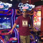Alumnus Rick Baltman in front of arcade games