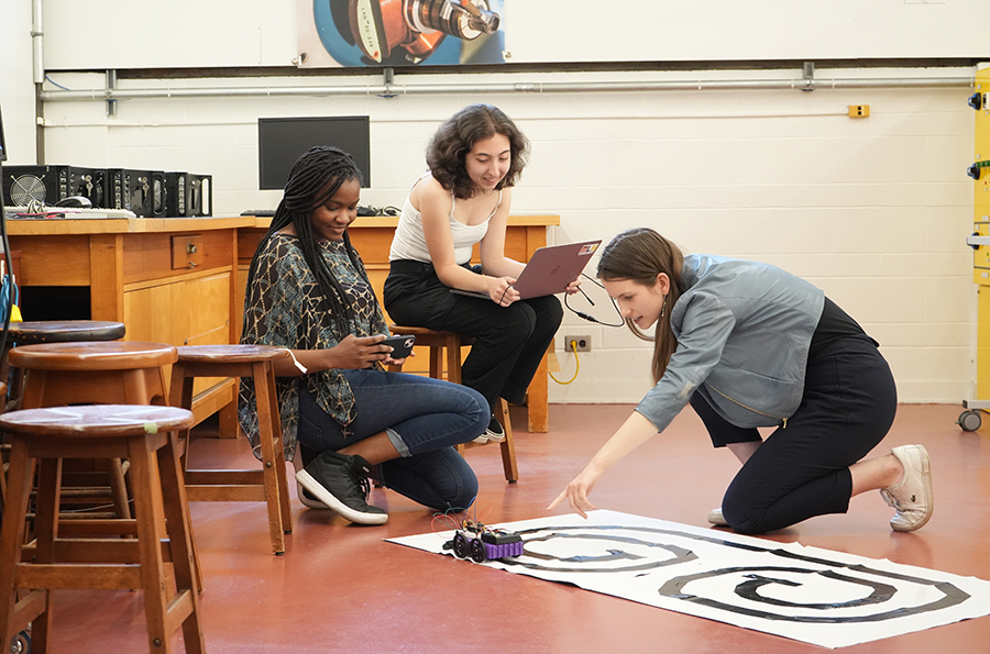 Left to right: The team of Racqueish Robinson (Year 1 CompE), Christina Pizzonia (Year 1 ElecE) and Sofiia Savchyn (Year 1 ElecE) test out their modifications to their robot. (Photo: Matthew Tierney)