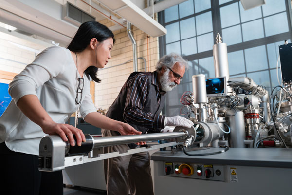 Pei-Yu Kuo, a PhD candidate in Forestry, and Rana Sodhi, Senior Research Associate and adjunct professor (ChemE), work on the new secondary ion mass spectrometer at the Characterization of Advanced Materials (OCCAM). (Photo: Neil Ta) 