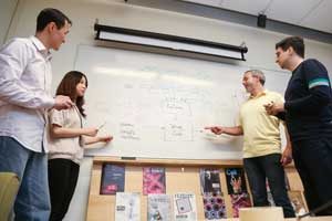 Professor Brenda Frey (ECE, second from right) is applying machine learning to genomics, teasing out the mutations that cause disease. (Photo: Roberta Baker)