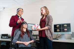 Professor Tom Chau (IBBME, left)) is developing techniques that could allow children with limited mobility, motor control or loss of speech to interact with the world around them. (Photo: Neil Ta)