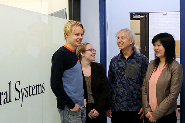 IBBME PhD candidate Vasily Grigorovsky, at left, uses computer models to investigate neurological mechanisms behind epileptic seizures. Led by Professor Berj Bardakjian (ECE, IBBME), second from right, and working closely with graduate students Vanessa Breton (second from left) and Helena Liu (right), this team is attempting to identify better treatment options for patients with epilepsy. (Credit: Luke Ng)