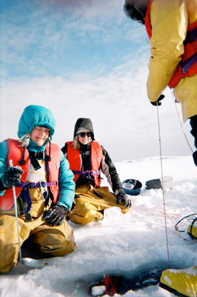 Lesley Warren (left) and her team take water samples at a site in Northern Ontario. By studying the microbes present in industrial process water — including their genomes —they aim to develop new strategies for preventing and managing pollution. (Photo courtesy Lesley Warren)