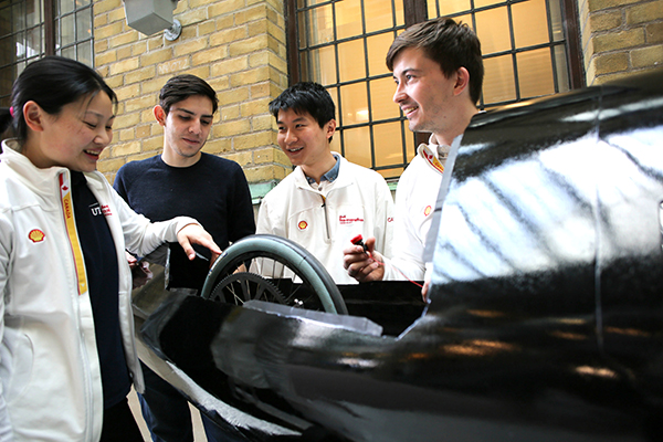 Supermileage Team co-captains Melissa Fung (Year 3 MechE + PEY, at far left) and Callum Bartlett (Year 3 MechE, far right) and their teammates examine the interior of their hyper-efficient prototype vehicle, called Shadow. The team is hopeful that their vehicle improvements will earn them a spot at the podium at this year’s Shell Eco-Marathon Americas race. (Credit: Roberta Baker).