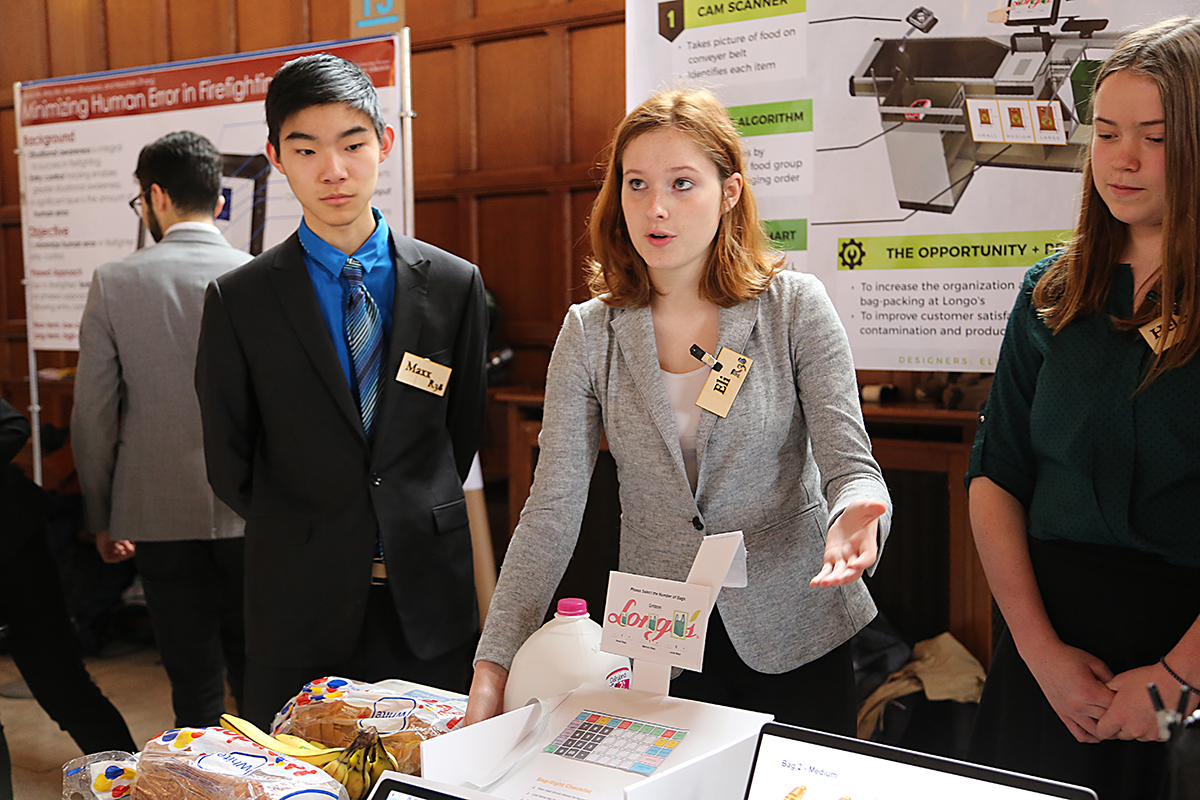 Engineering science student Eli Scott (centre) presents her team’s design for expediting the use of reusable bags at Longo’s grocery stores. (Photo: Liz Do)