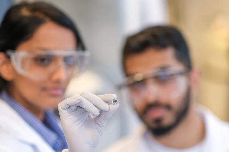 IBBME researchers Buddhisha Udugama (left) and Pranav Kadhiresan (right) hold a miniaturized lithium heater. (Photo: Qin Dai)