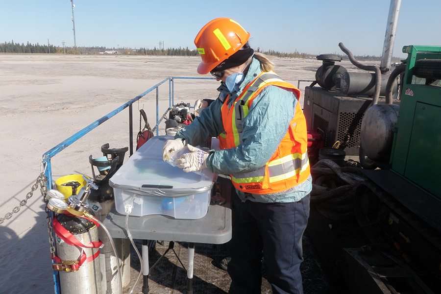 Professor Lesley Warren performs environmental sampling at Syncrude Canada’s Base Mine Lake, an important location for mining-impact water research and technology development in Alberta’s Oil Sands. (Photo courtesy Lesley Warren)