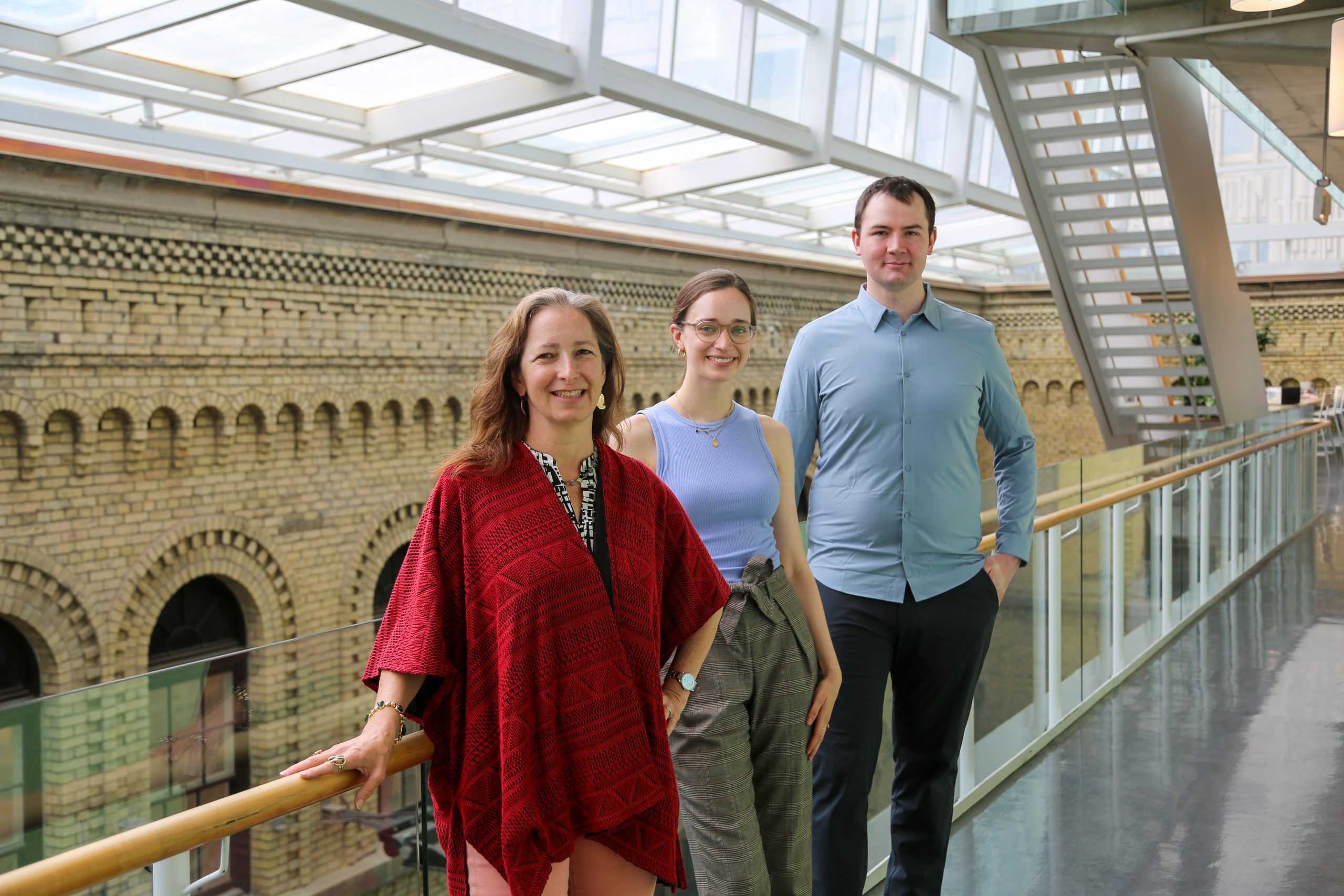 Professor Molly Shoichet (ChemE, BME), Laura Bahlmann (BME PhD candidate) and Dr. Alexander Baker (ChemE, BME) stand together at the Terrence Donnelly Centre for Cellular &amp; Biomolecular Research. (Photo: Safa Jinje)