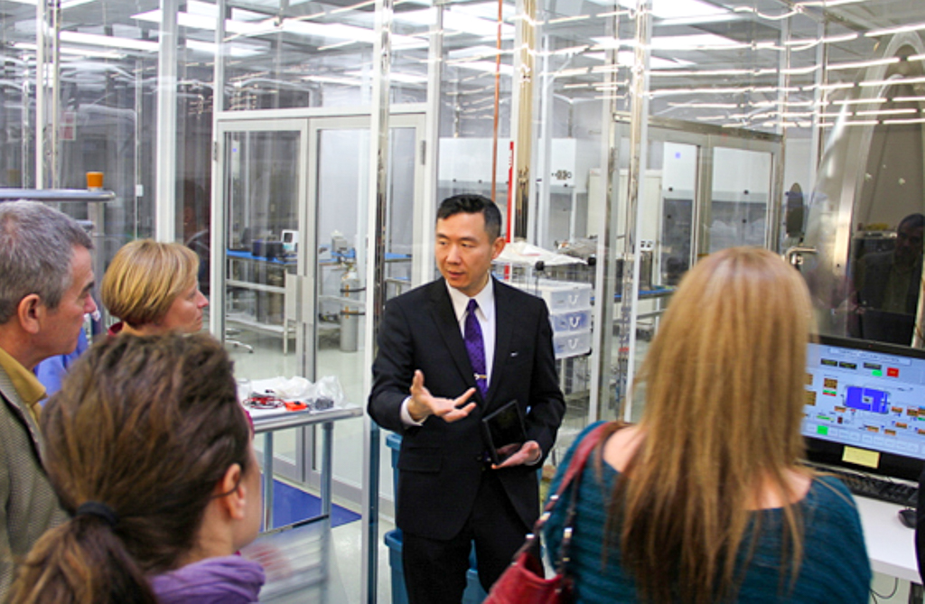 A group of people on a tour of an aerospace laboratory.