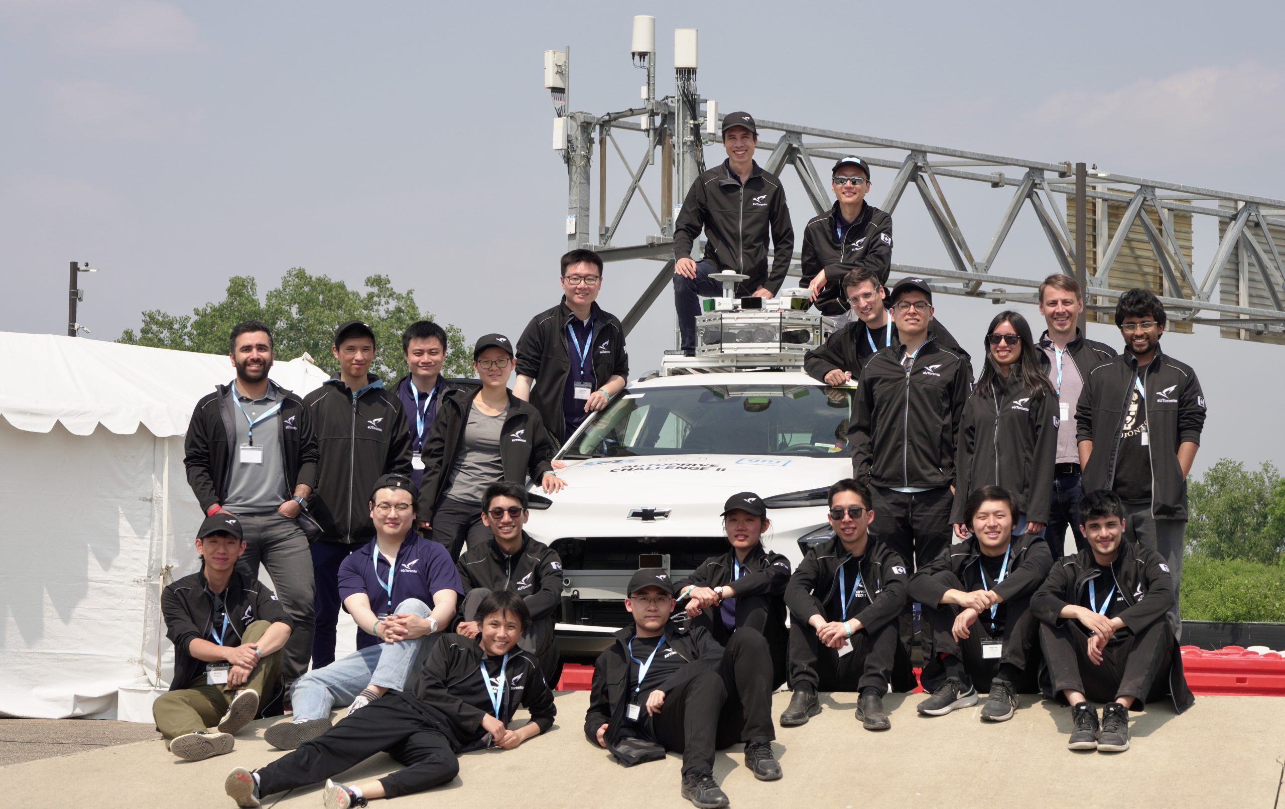 Members of the aUToronto pose outside with their autonomous vehicle.