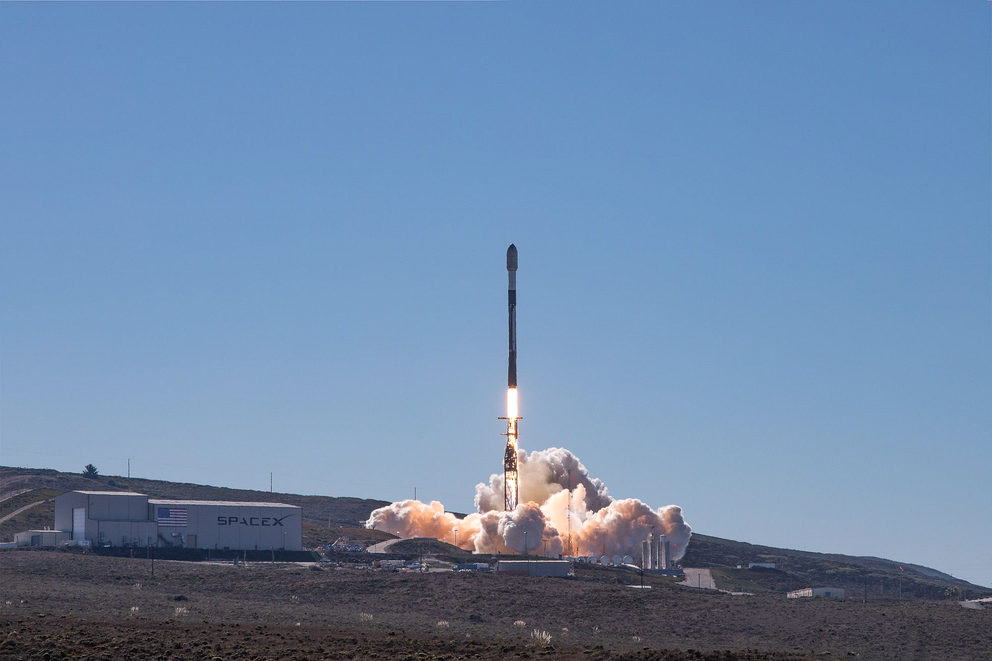 A rocket lifts off into the sky.