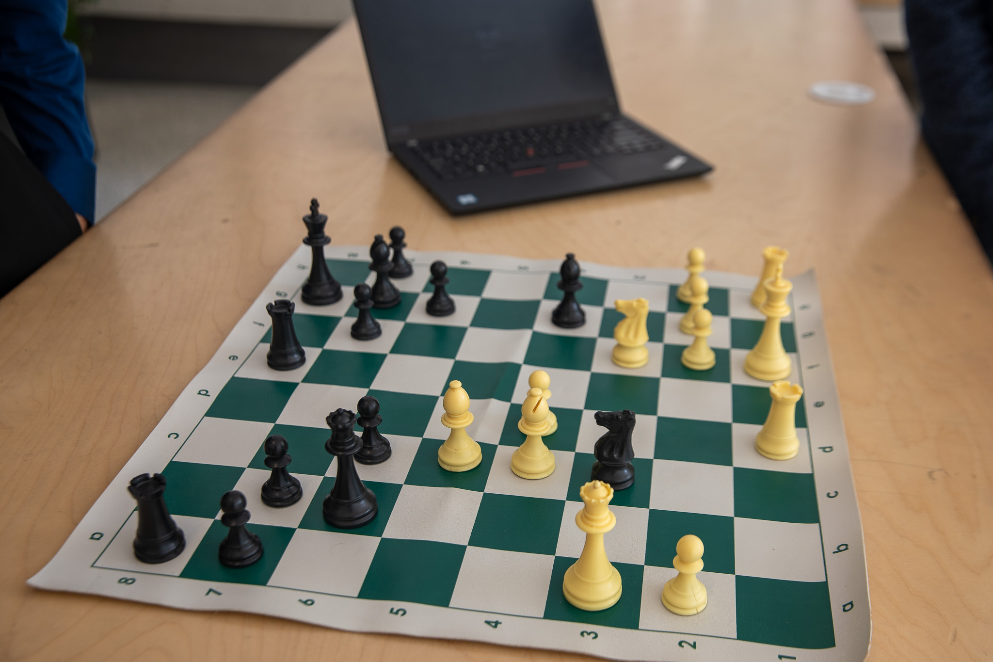 A close up of a chess game depicting a move from the “Game of the Century,” where Bobby Fischer (black) sacrifices his queen in a celebrated brilliant move.