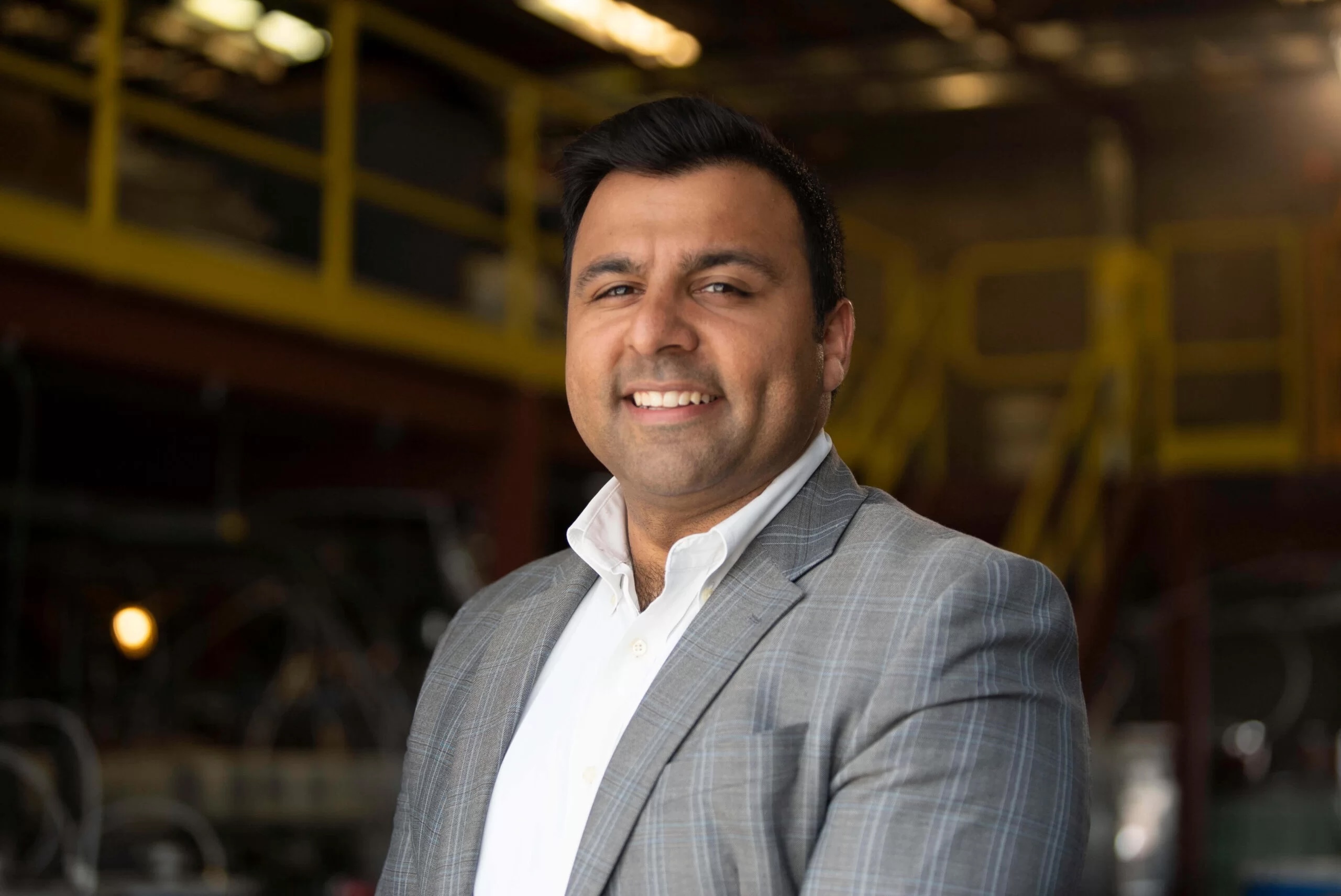 Kochhar, in a suit, smiles at the camera