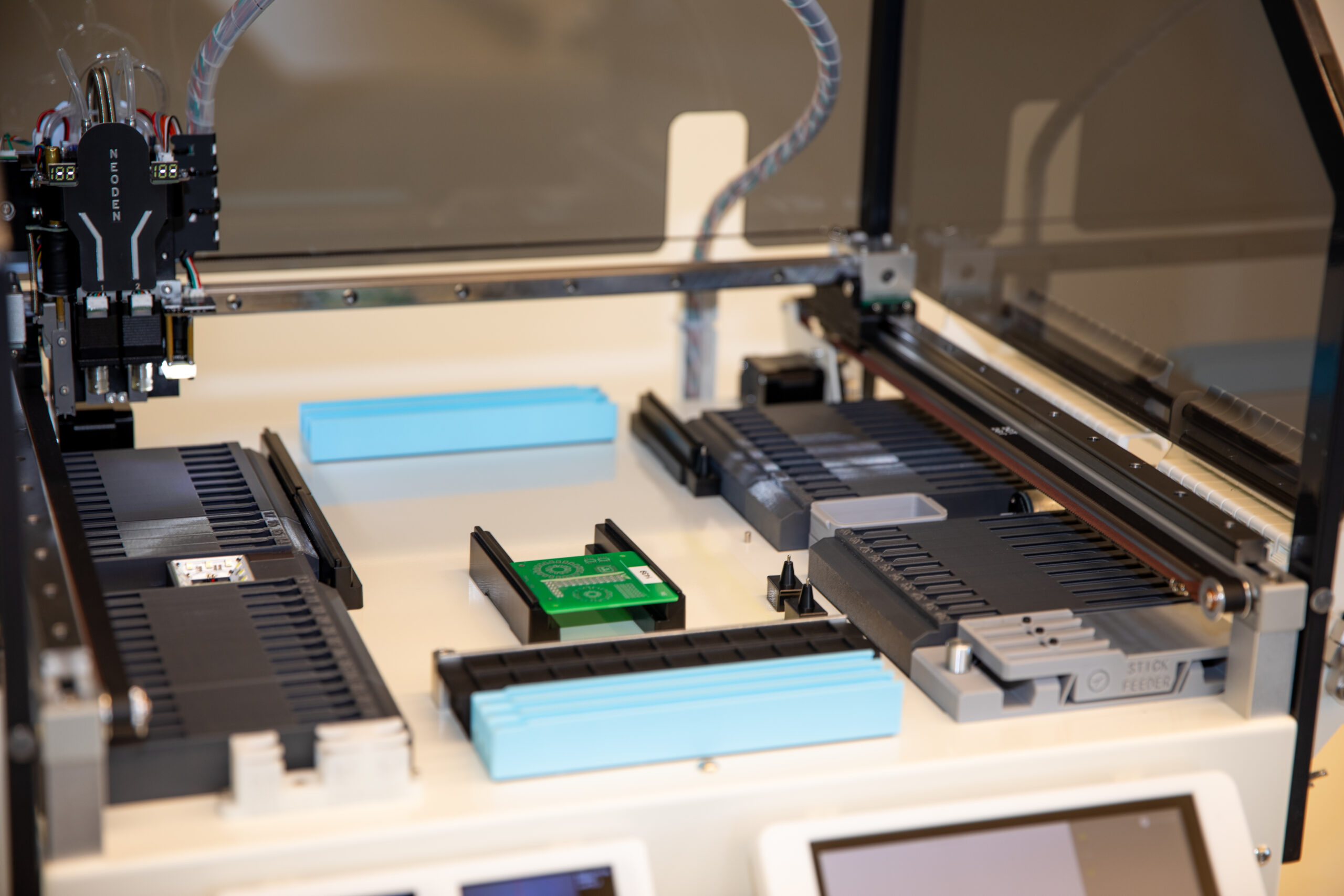 a close up photo of a NeoDen YY1 Pick and Place machine