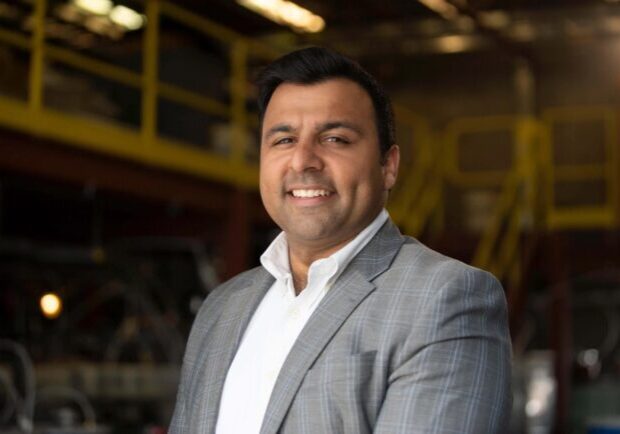 Ajay-Kochhar-scaled.jpg copy Kochhar, in a suit, smiles at the camera