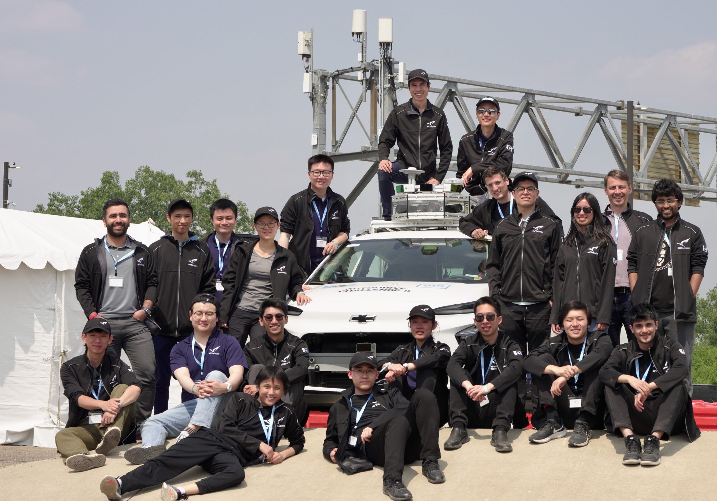 Members of the aUToronto pose outside with their autonomous vehicle.
