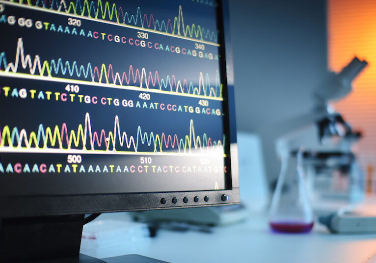 Deep-Genomics Computer monitor with lab equipment in the background