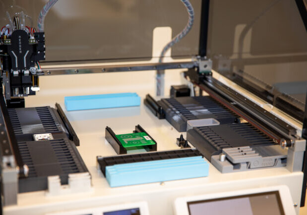 a close up photo of a NeoDen YY1 Pick and Place machine