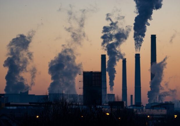 Emissions are seen rising from an industrial facility. Professor Greg Evans (ChemE) studies connections between air pollution and human health. (Photo: Ella Ivanescu / Unsplash)  