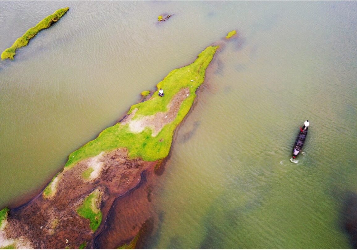 A river basin with visible algae and rock formation.